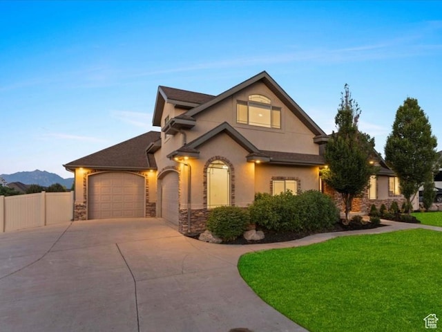 12469 S Patriot Hill Way, Herriman, UT 84096 - view of front of house with concrete driveway, stucco siding, an attached garage, and stone siding