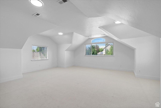 12469 S Patriot Hill Way, Herriman, UT 84096 - additional living space featuring carpet flooring, vaulted ceiling, and healthy amount of natural light