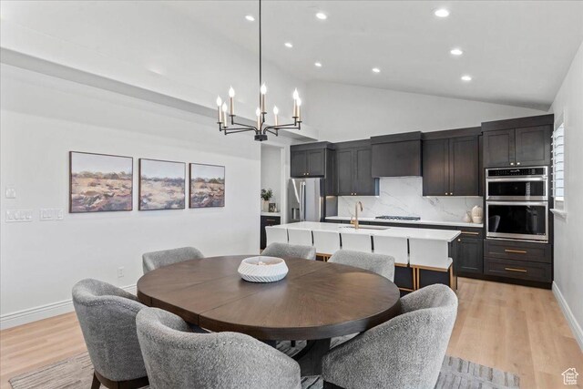12469 S Patriot Hill Way, Herriman, UT 84096 - dining area featuring lofted ceiling, a chandelier, light wood finished floors, and recessed lighting