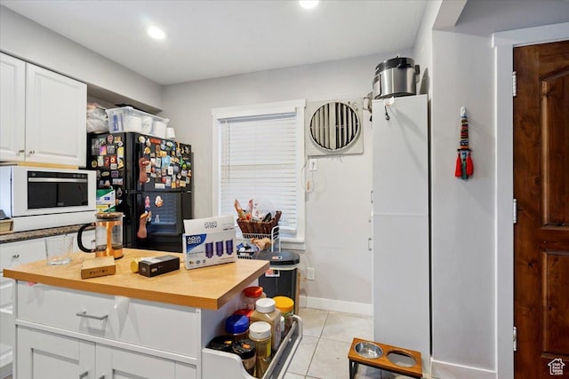 344 E Utopia Ave, South Salt Lake, UT 84115 - kitchen with freestanding refrigerator, white cabinets, light tile patterned flooring, and recessed lighting