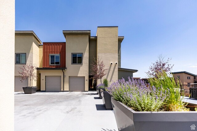 6169 Park Ln S Unit 36, Park City, UT 84098 - view of front facade featuring concrete driveway, a garage, and stucco siding