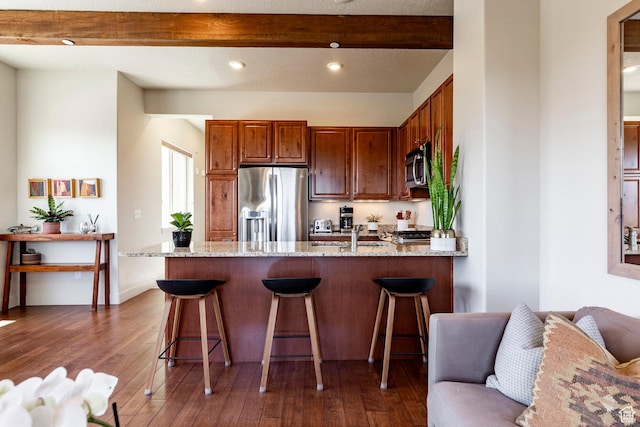 6169 Park Ln S Unit 36, Park City, UT 84098 - kitchen featuring appliances with stainless steel finishes, a peninsula, light stone counters, dark wood-style floors, and beamed ceiling