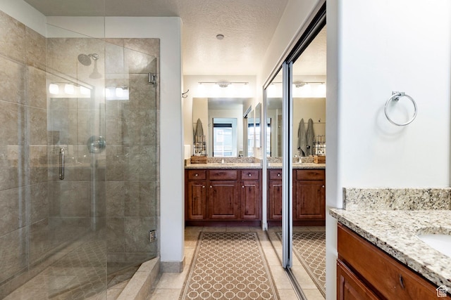 6169 Park Ln S Unit 36, Park City, UT 84098 - bathroom featuring two vanities, a shower stall, and tile patterned flooring