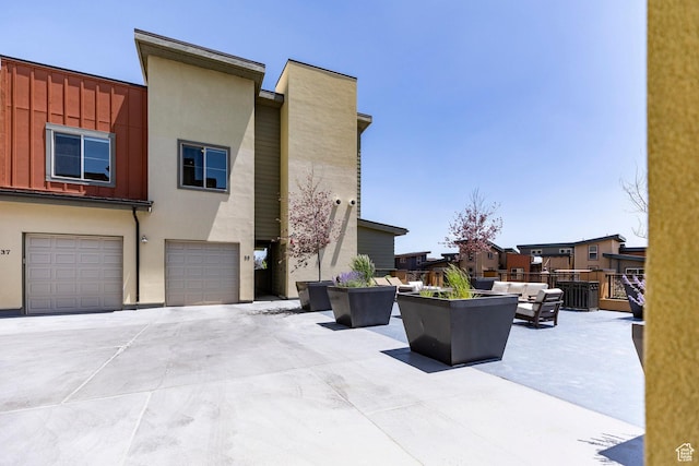 6169 Park Ln S Unit 36, Park City, UT 84098 - view of side of property with outdoor lounge area, a garage, stucco siding, and driveway
