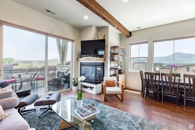 6169 Park Ln S Unit 36, Park City, UT 84098 - living area featuring beam ceiling, hardwood / wood-style floors, a multi sided fireplace, and recessed lighting