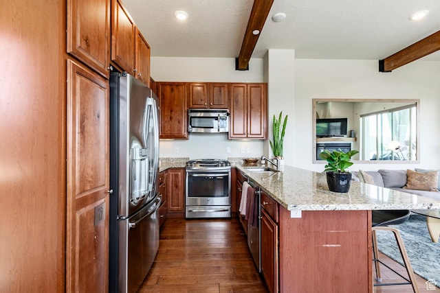 6169 Park Ln S Unit 36, Park City, UT 84098 - kitchen with stainless steel appliances, beam ceiling, a peninsula, dark wood finished floors, and a breakfast bar area