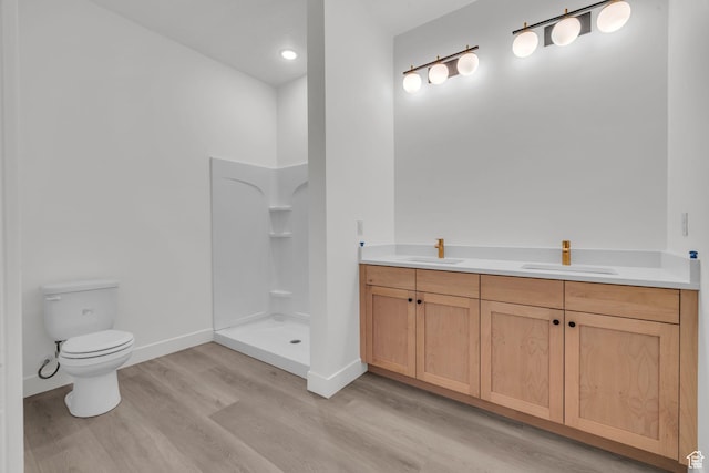 147 W Marigold Cir Unit 310, Stansbury Park, UT 84074 - bathroom with wood finished floors, a stall shower, and double vanity