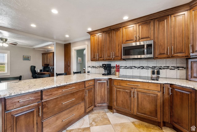 2214 S 1600 E, Preston, ID 83263 - kitchen featuring stainless steel microwave, a peninsula, decorative backsplash, recessed lighting, and light stone counters