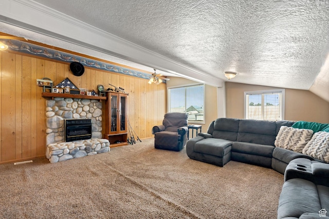 2214 S 1600 E, Preston, ID 83263 - living area with carpet floors, a fireplace, a textured ceiling, wood walls, and vaulted ceiling