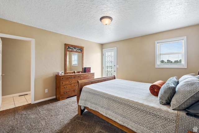 2214 S 1600 E, Preston, ID 83263 - carpeted bedroom featuring a textured ceiling and tile patterned floors