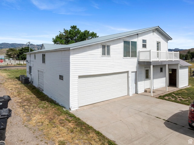 2214 S 1600 E, Preston, ID 83263 - view of front of property with a garage, a mountain view, a balcony, and concrete driveway