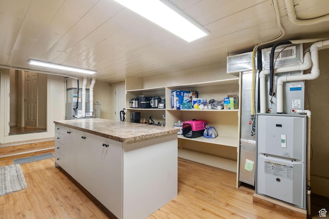 2214 S 1600 E, Preston, ID 83263 - kitchen with light wood finished floors, white cabinets, light countertops, a center island, and open shelves