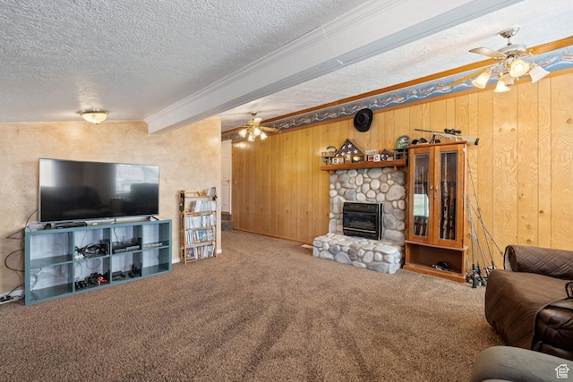 2214 S 1600 E, Preston, ID 83263 - living area featuring ceiling fan, a textured ceiling, carpet flooring, a stone fireplace, and ornamental molding