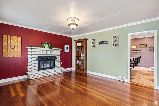 2214 S 1600 E, Preston, ID 83263 - unfurnished living room with hardwood / wood-style flooring, crown molding, and a fireplace