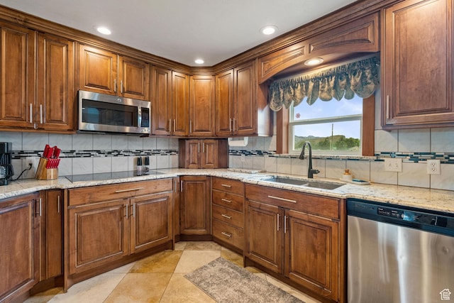 2214 S 1600 E, Preston, ID 83263 - kitchen featuring appliances with stainless steel finishes, decorative backsplash, light stone countertops, recessed lighting, and brown cabinetry