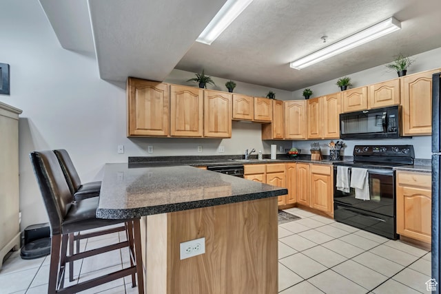 1245 E Privet Dr S Unit B3-427, Cottonwood Heights, UT 84121 - kitchen with black appliances, a breakfast bar area, light tile patterned floors, light brown cabinets, and a textured ceiling