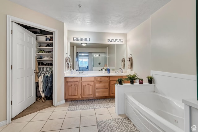 1245 E Privet Dr S Unit B3-427, Cottonwood Heights, UT 84121 - bathroom featuring a bath, double vanity, tile patterned flooring, a walk in closet, and a textured ceiling