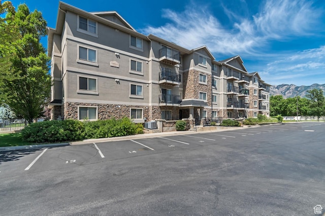 1245 E Privet Dr S Unit B3-427, Cottonwood Heights, UT 84121 - view of apartment building / complex with uncovered parking and a mountain view