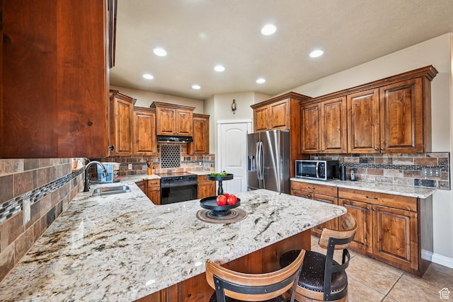 3195 N 1350 W, Pleasant View, UT 84414 - kitchen with appliances with stainless steel finishes, under cabinet range hood, decorative backsplash, a peninsula, and recessed lighting