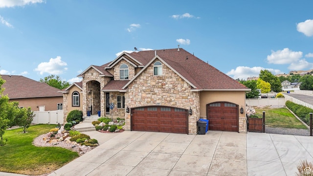 3195 N 1350 W, Pleasant View, UT 84414 - view of front of house featuring stone siding, concrete driveway, a gate, and an attached garage