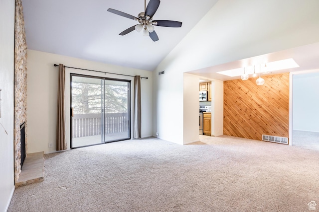 6955 N 2200 W Unit 4E, Park City, UT 84098 - unfurnished living room featuring light carpet, wood walls, ceiling fan, high vaulted ceiling, and a fireplace