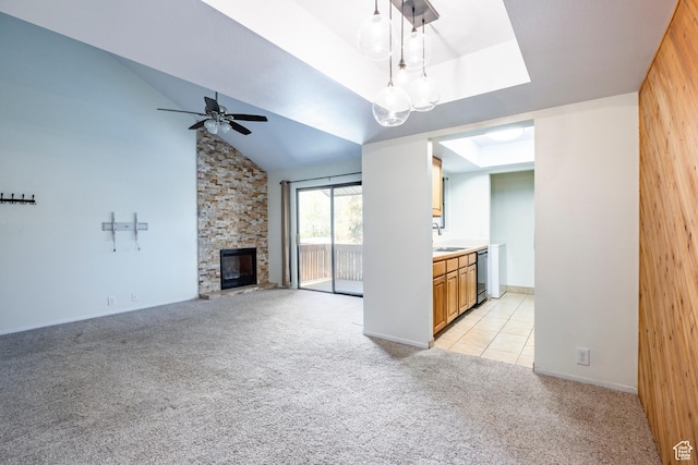 6955 N 2200 W Unit 4E, Park City, UT 84098 - unfurnished living room with light colored carpet, a stone fireplace, and ceiling fan