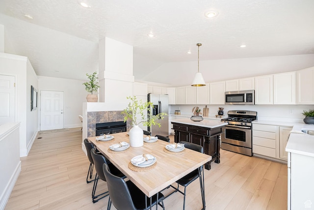 383 E Manti Dr S, Draper, UT 84020 - kitchen featuring stainless steel appliances, lofted ceiling, light countertops, light wood-style flooring, and white cabinets