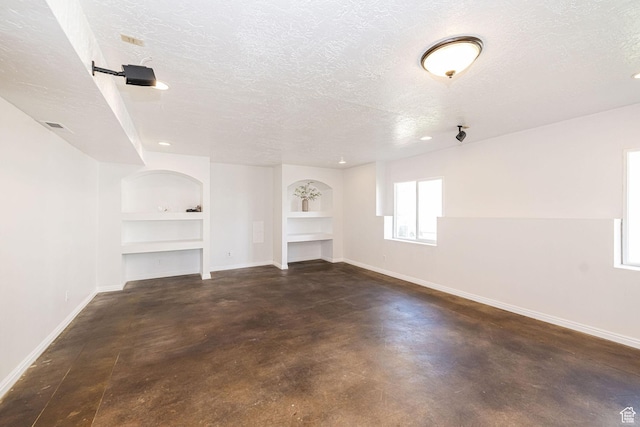 383 E Manti Dr S, Draper, UT 84020 - unfurnished living room with a textured ceiling, built in features, and finished concrete floors