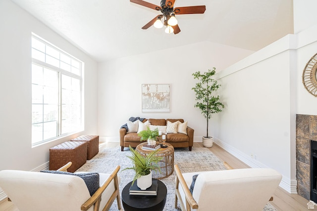 383 E Manti Dr S, Draper, UT 84020 - living area with a ceiling fan, light wood-style floors, a tiled fireplace, and lofted ceiling