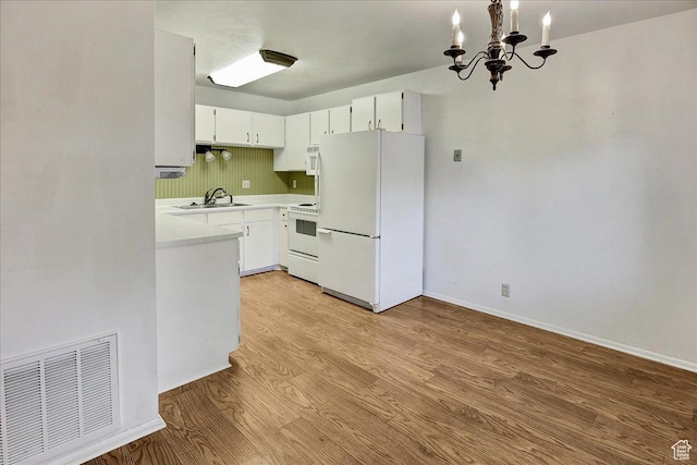 1917 S Main St Unit 7A, Bountiful, UT 84010 - kitchen with white appliances, a chandelier, light countertops, light wood finished floors, and white cabinetry