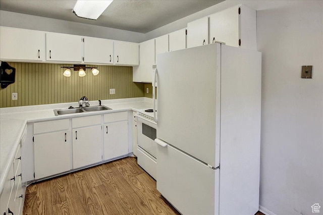 1917 S Main St Unit 7A, Bountiful, UT 84010 - kitchen with white appliances, light wood finished floors, white cabinetry, and light countertops