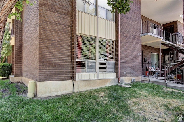 1917 S Main St Unit 7A, Bountiful, UT 84010 - view of side of home with brick siding, stairway, and a lawn