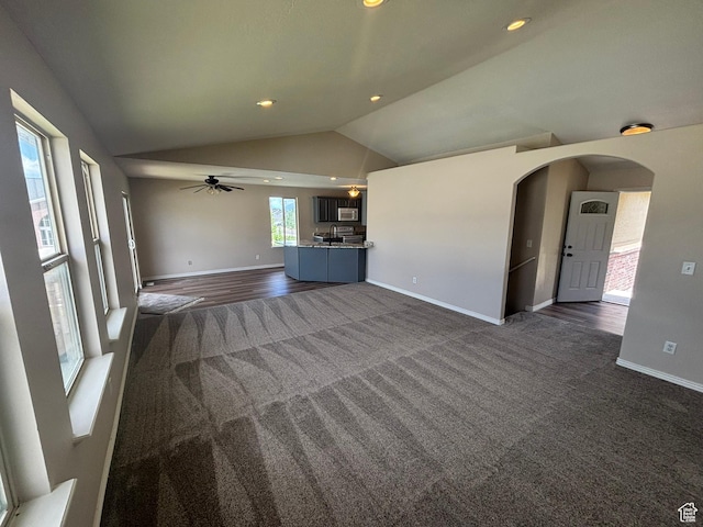 576 S 400 E, Santaquin, UT 84655 - unfurnished living room with dark colored carpet, vaulted ceiling, arched walkways, a ceiling fan, and recessed lighting