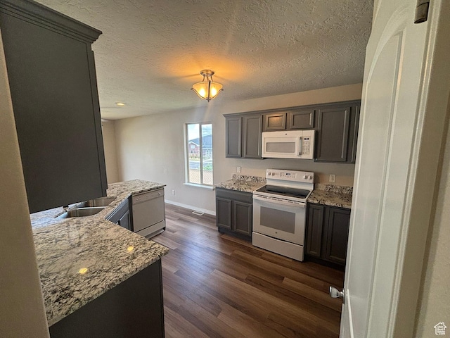 576 S 400 E, Santaquin, UT 84655 - kitchen with white appliances, dark wood-style floors, light stone countertops, and a textured ceiling