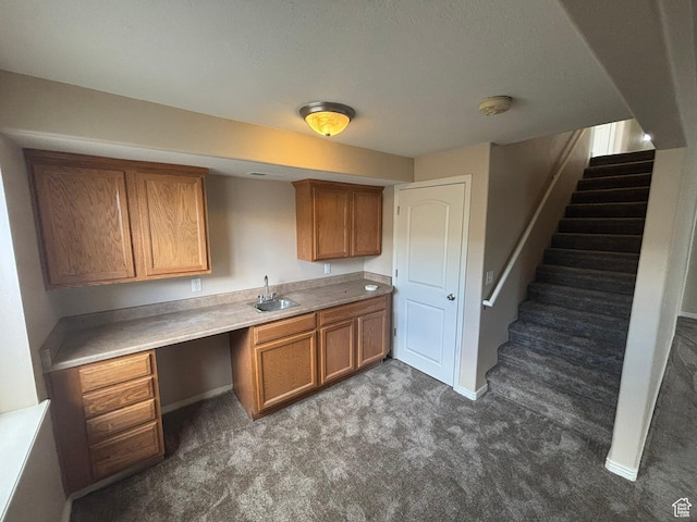 576 S 400 E, Santaquin, UT 84655 - kitchen with brown cabinets, carpet floors, built in study area, and light countertops