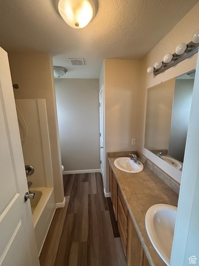 576 S 400 E, Santaquin, UT 84655 - full bath with wood finished floors, a textured ceiling, double vanity, and bathtub / shower combination