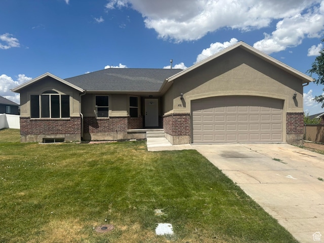 576 S 400 E, Santaquin, UT 84655 - ranch-style house with brick siding, a front yard, and a garage