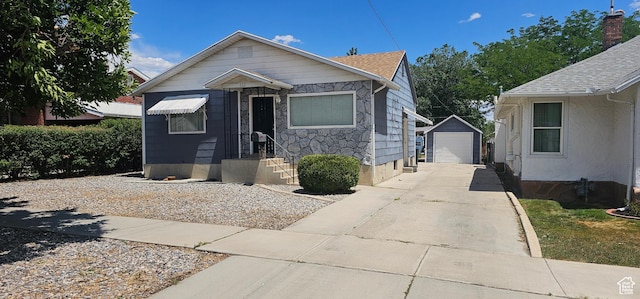 660 N 300 E, Price, UT 84501 - bungalow-style house with an outbuilding, a detached garage, concrete driveway, and stone siding