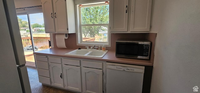 660 N 300 E, Price, UT 84501 - kitchen with dishwasher, stainless steel microwave, white cabinets, light countertops, and a textured wall