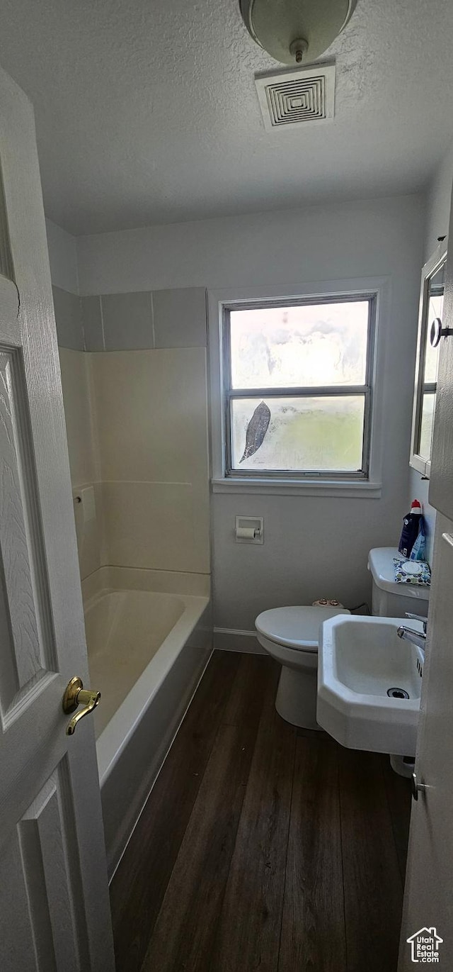 660 N 300 E, Price, UT 84501 - full bathroom with wood finished floors, healthy amount of natural light, and a textured ceiling