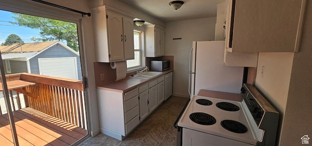 660 N 300 E, Price, UT 84501 - kitchen featuring white appliances and white cabinetry