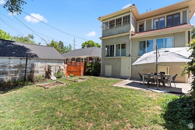 368 S 1100 E, Salt Lake City, UT 84102 - rear view of house with a vegetable garden, stucco siding, a patio area, and a tiled roof