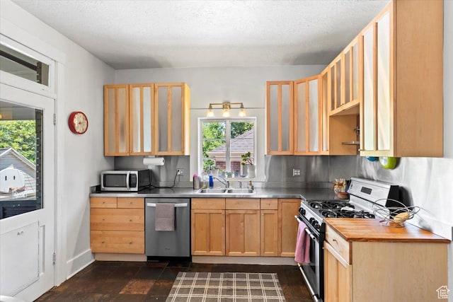 368 S 1100 E, Salt Lake City, UT 84102 - kitchen with appliances with stainless steel finishes, light brown cabinetry, glass insert cabinets, and a textured ceiling