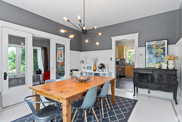 368 S 1100 E, Salt Lake City, UT 84102 - dining space with a decorative wall, a chandelier, and wainscoting