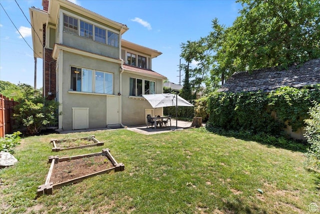 368 S 1100 E, Salt Lake City, UT 84102 - back of house with stucco siding, a patio, and a vegetable garden