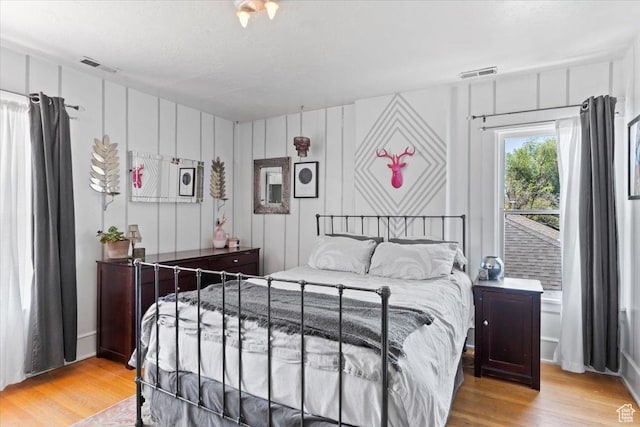368 S 1100 E, Salt Lake City, UT 84102 - bedroom featuring wood finished floors and a decorative wall