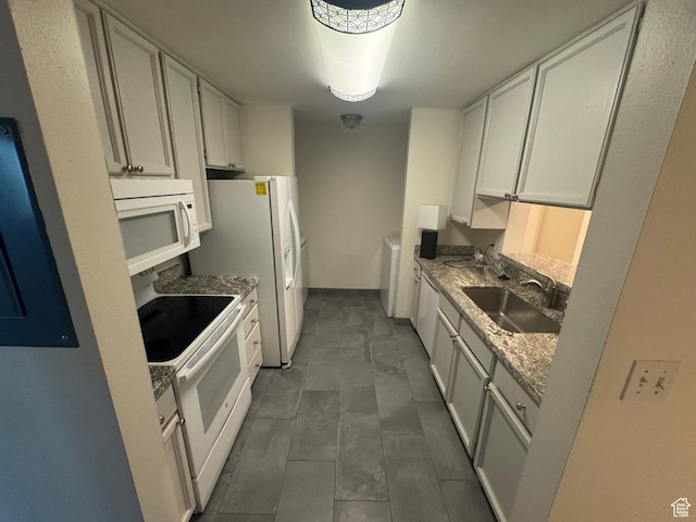 550 400 E Unit 3307, Salt Lake City, UT 84111 - kitchen featuring white appliances, white cabinetry, and light stone counters