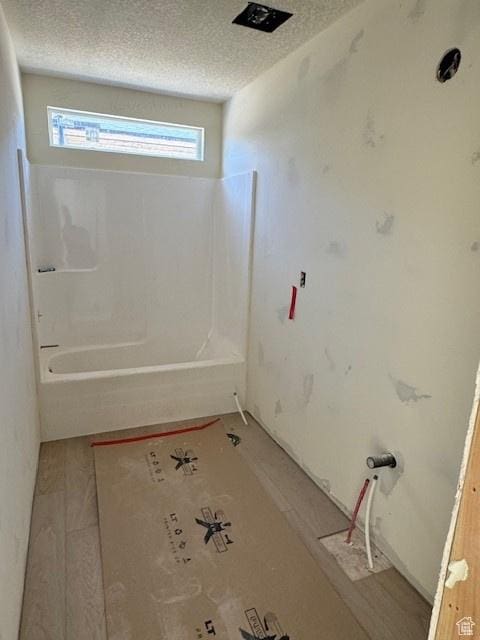 432 W Sapphire Dr Unit 7012, Tooele, UT 84074 - bathroom featuring a textured ceiling and tub / shower combination