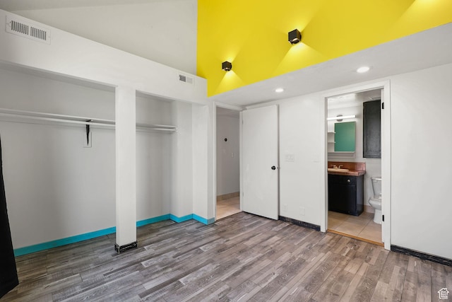 1428 W Beacon Hill Cir S Unit 1428, Salt Lake City, UT 84123 - unfurnished bedroom with high vaulted ceiling, wood finished floors, two closets, connected bathroom, and recessed lighting