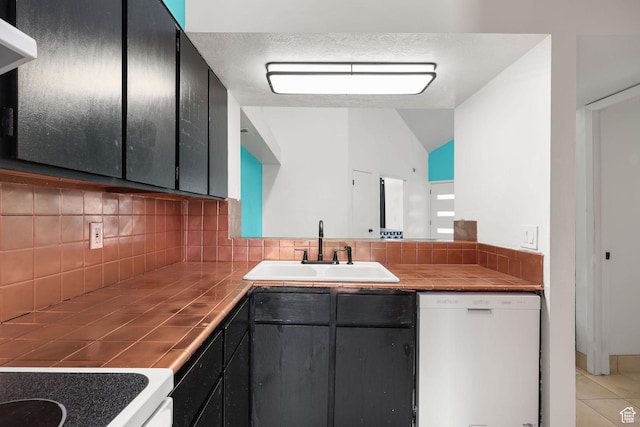 1428 W Beacon Hill Cir S Unit 1428, Salt Lake City, UT 84123 - kitchen with dishwasher, tile countertops, backsplash, vaulted ceiling, and light tile patterned floors